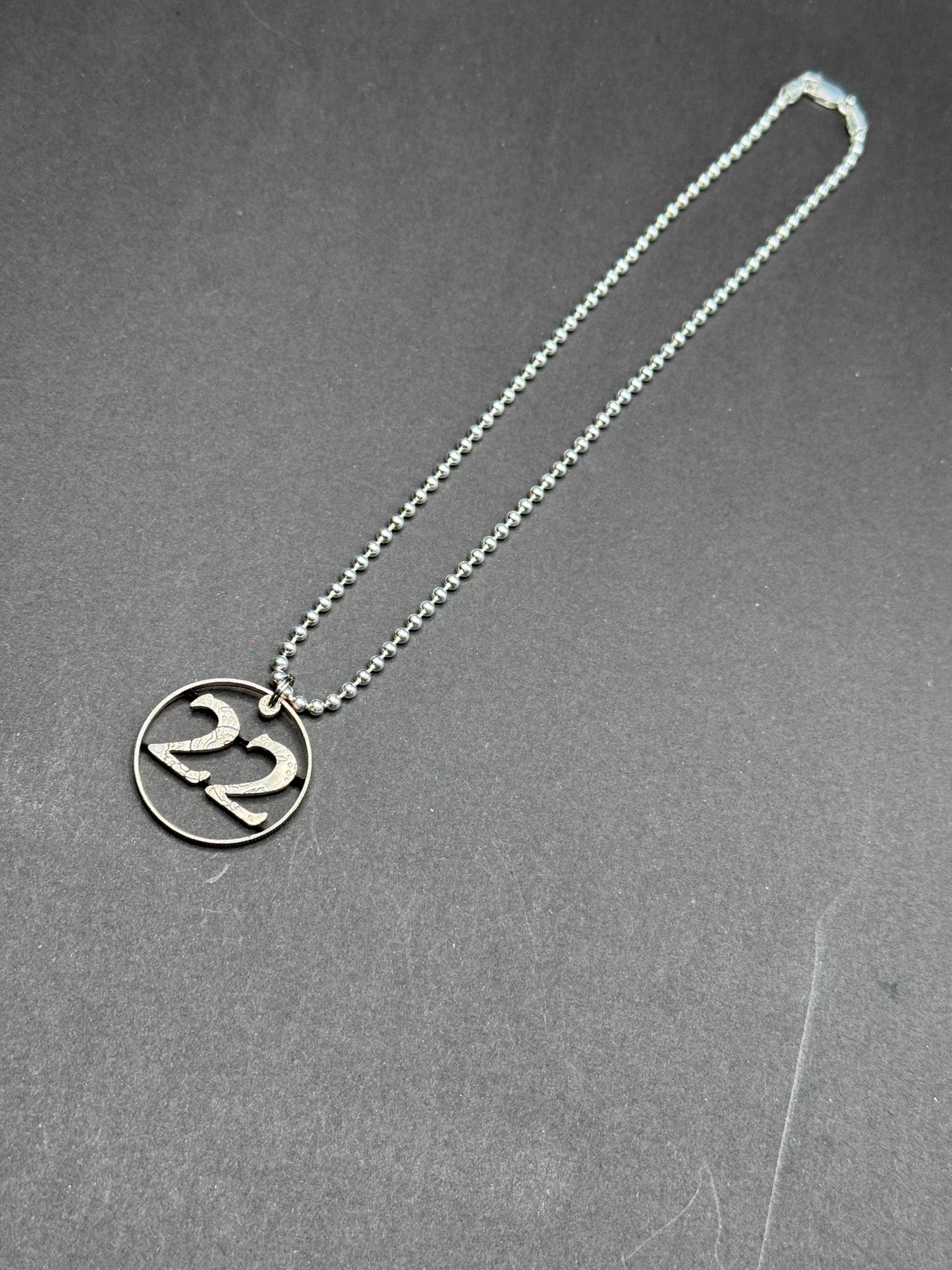 22 A DAY - Carved Coin Pendant on Sterling Silver chain