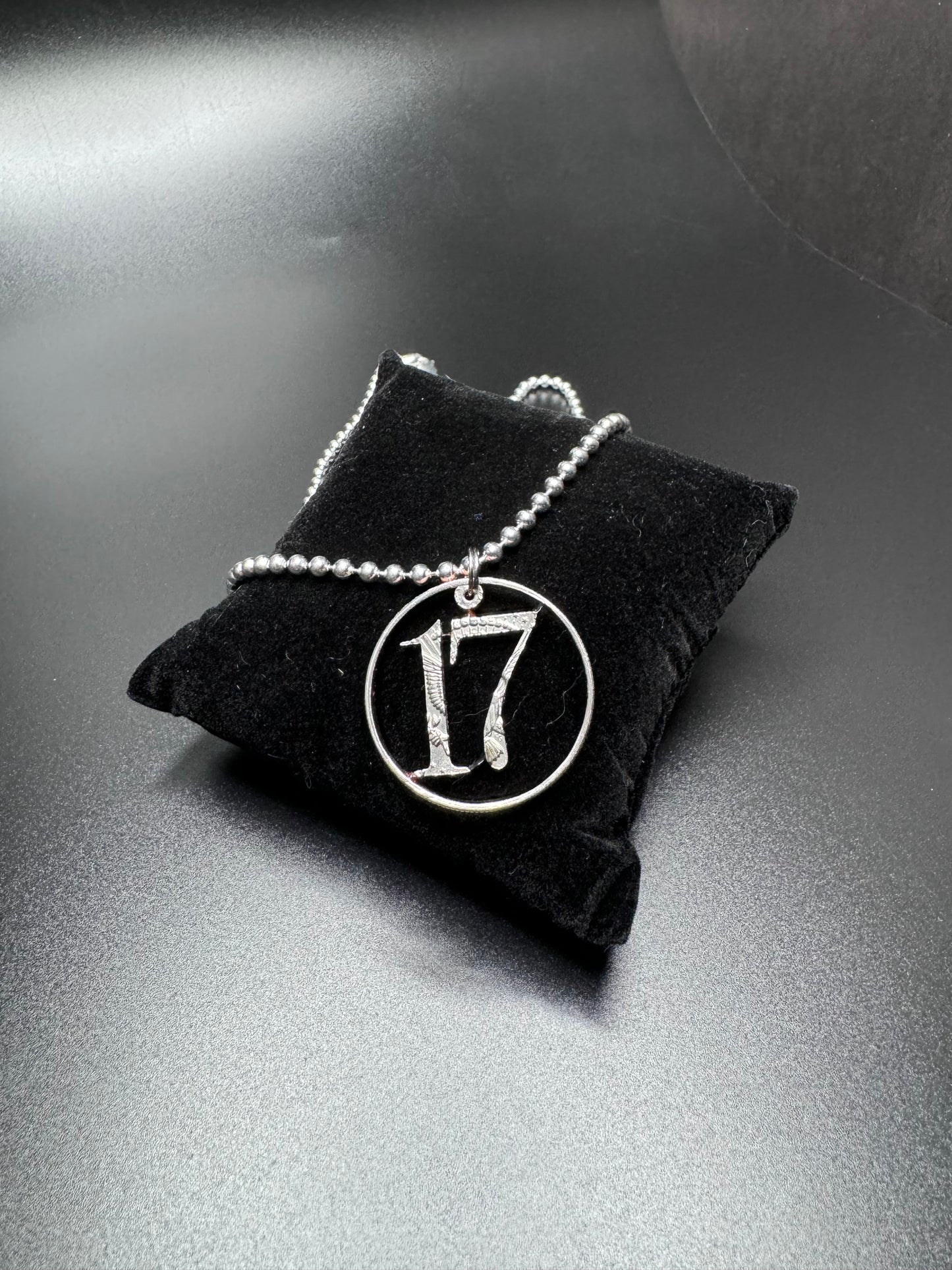 17 carved coin pendant/ sterling silver chain