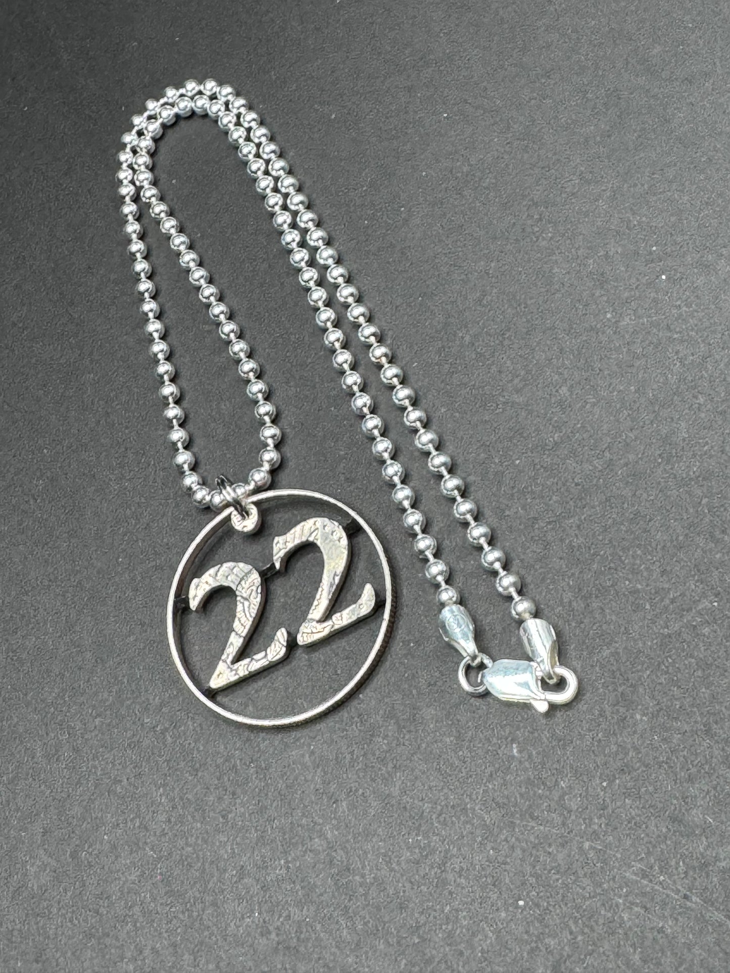 22 A DAY - Carved Coin Pendant on Sterling Silver chain